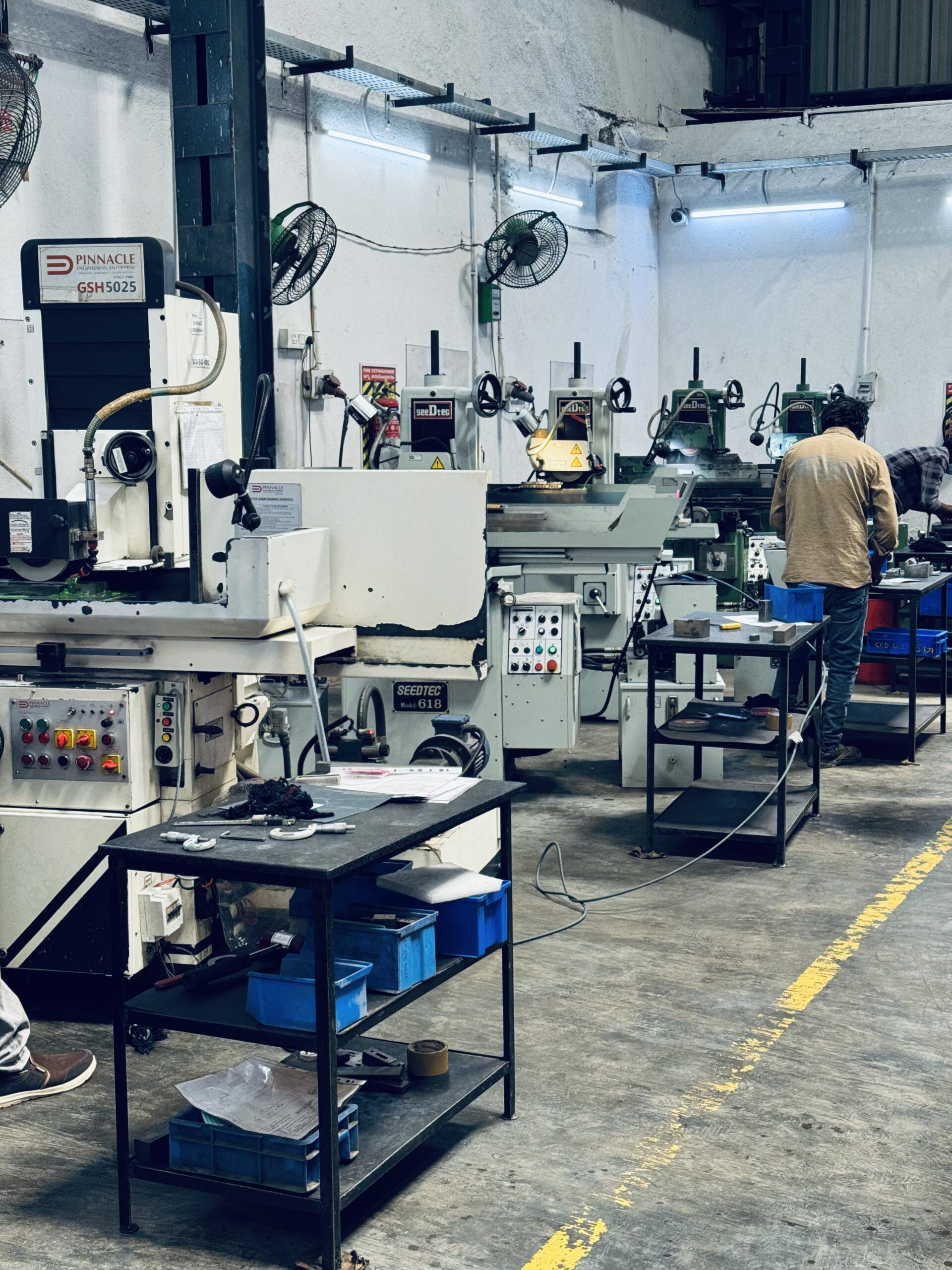 Precision surface grinding and tool-making facility at Concord United Products Private Limited, featuring advanced grinding machinery for manufacturing high-tolerance pelletizer blades, pelletizing dies, and black masterbatch processing components.