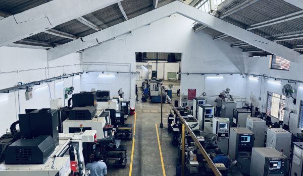 Overhead view of the CNC machining and manufacturing bay at Concord United Products Private Limited, showcasing precision engineering of industrial blades, pelletizer knives, and masterbatch processing dies.